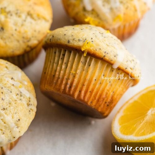 15 Delightful Easter Desserts to Impress Your Guests 17 Randomly placed lemon poppy seed muffins on a parchment paper-lined baking sheet with half of a lemon.