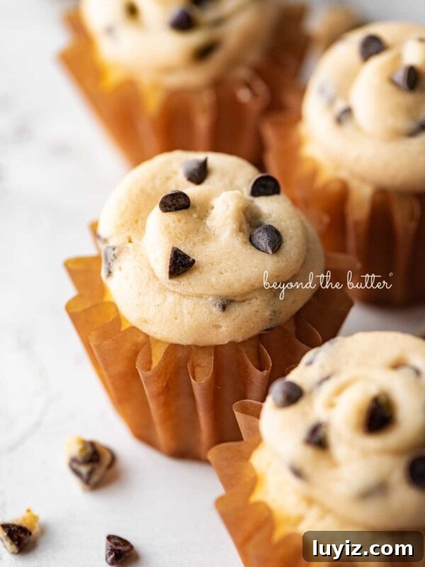 15 Delightful Easter Desserts to Impress Your Guests 21 Small batch chocolate chip cookie dough cupcakes on a white marbled background.