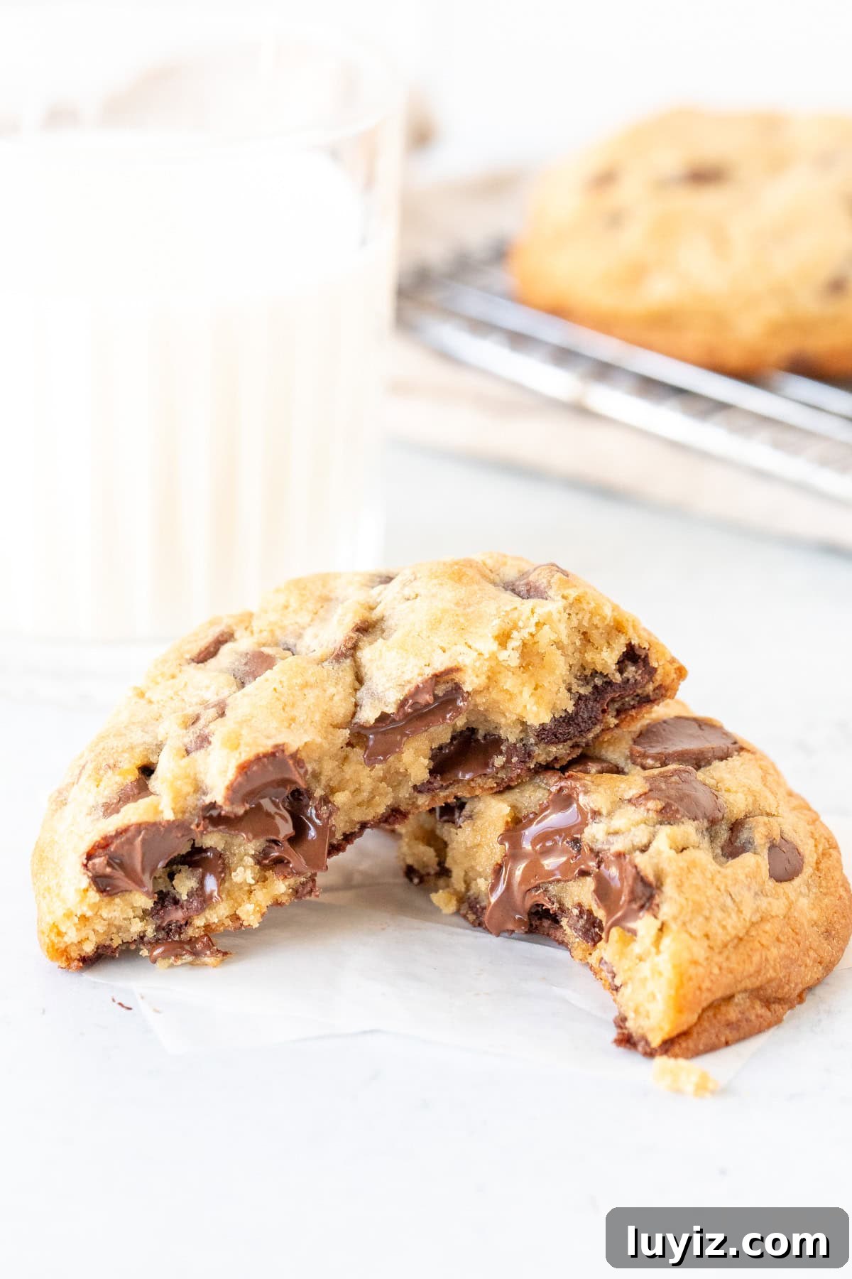 Chewy Thick Chocolate Chip Cookie Recipe for Perfect Results 3 Thick chocolate chip cookie broken in half with a glass of milk