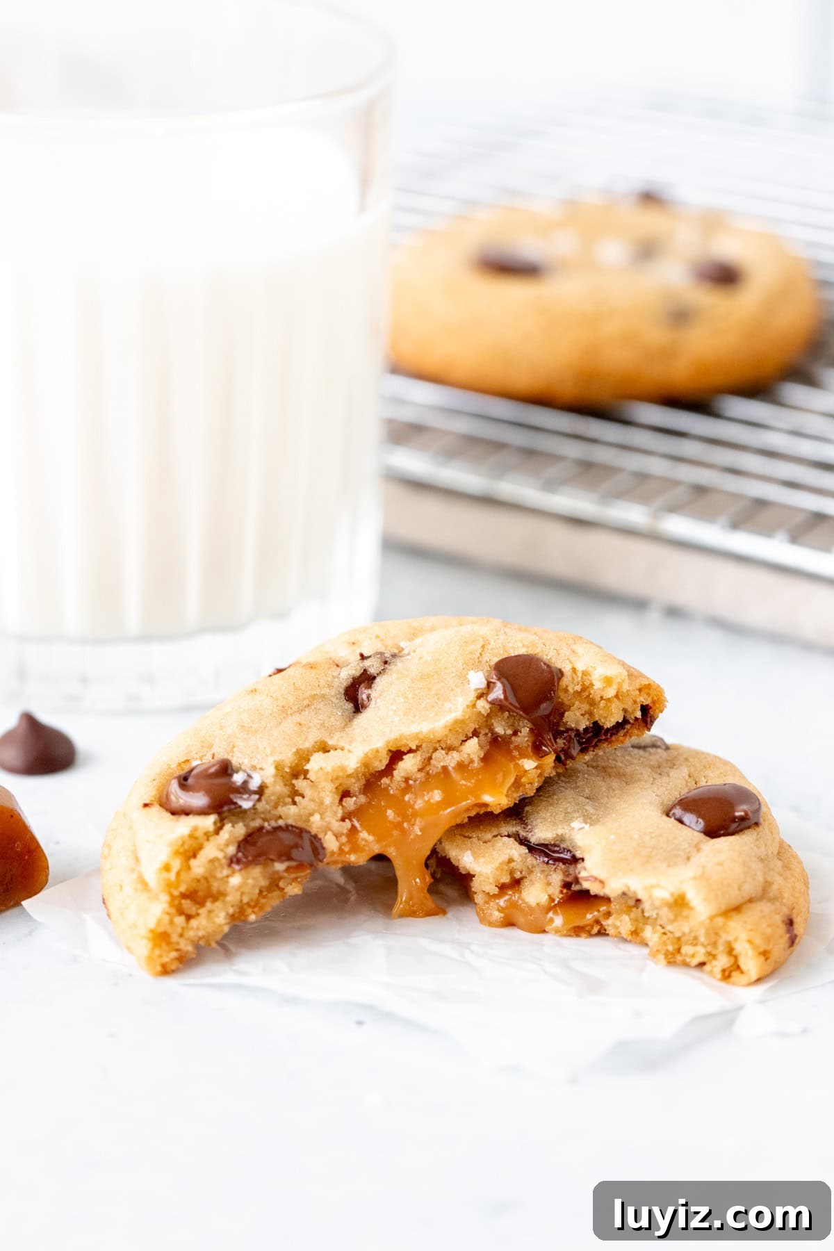 Chewy Caramel Chocolate Chip Cookies Recipe for Perfect Bakes 3 Caramel chocolate chip cookie, broken in half with glass of milk