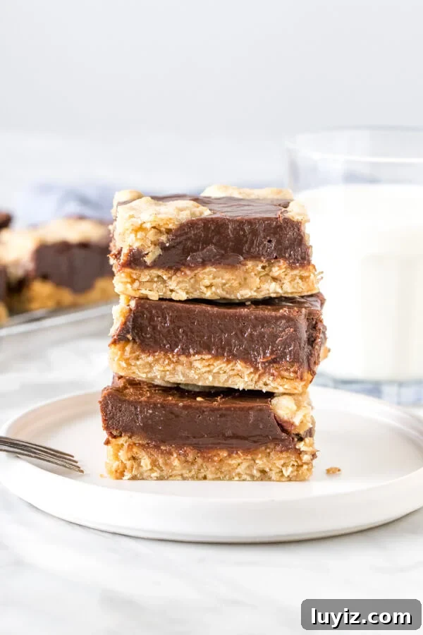 Chewy Oatmeal Fudge Bars with Chocolate Swirls 2 Stack of 3 oatmeal fudge bars with a glass of milk.