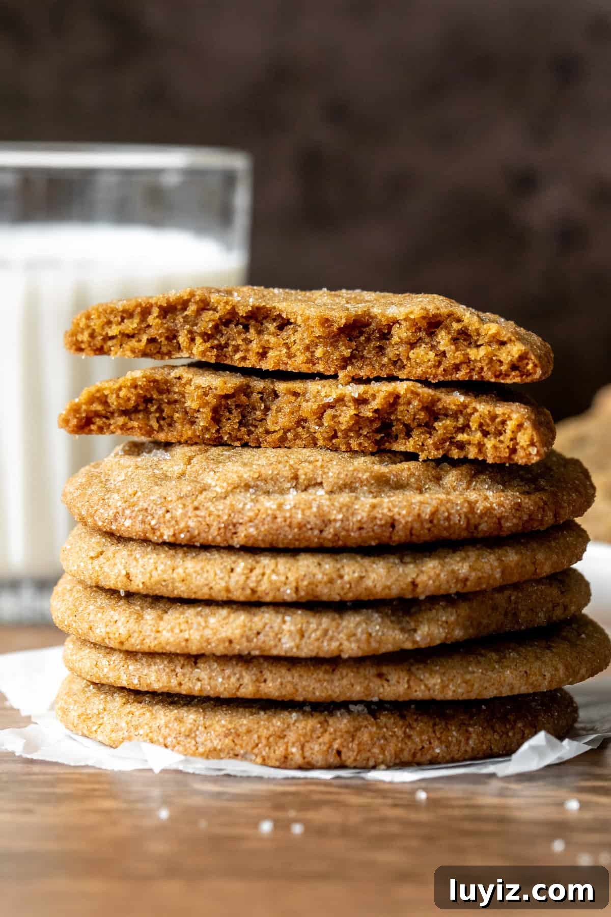 Chewy Brown Sugar Cookies Recipe for Soft, Caramelized Flavor 8 Stack of brown sugar cookies with top cookie broken in half with glasss of milk