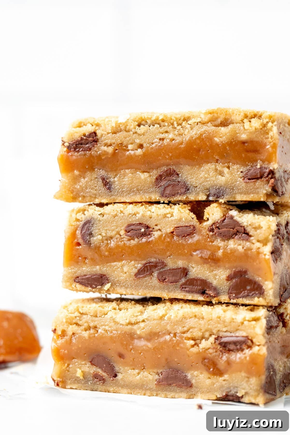 Salted Caramel Chocolate Chip Cookie Bars: Gooey & Chewy Recipe 3 Three salted caramel chocolate chip cookie bars, stacked on top of each other