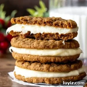 Gingerbread Oatmeal Cream Pies Recipe — Soft Spiced Sandwich Cookies 8 Gingerbread oatmeal sandwich cookies on top of each other, with top cookie broken in half
