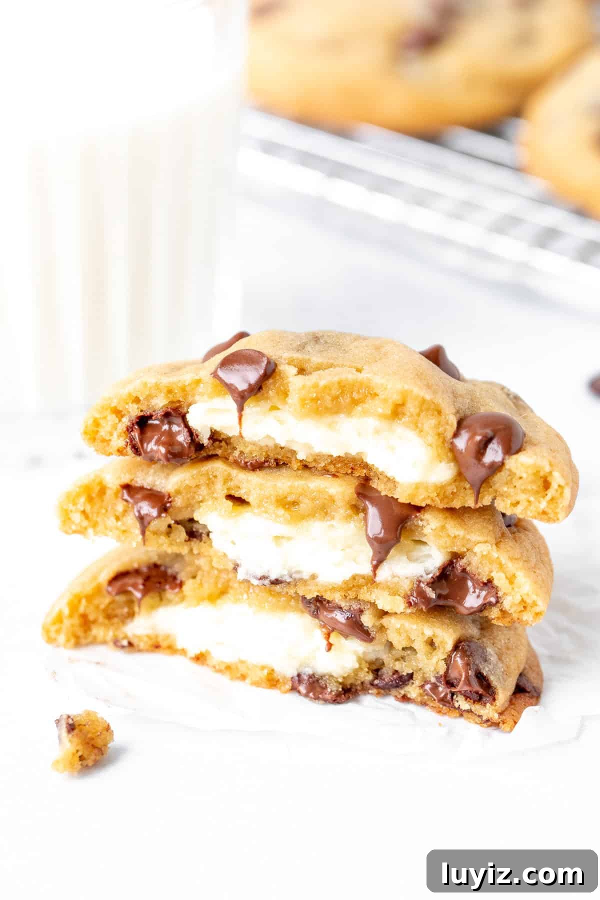 Cheesecake-Stuffed Chocolate Chip Cookies — Decadent Dessert Recipe 2 Three halves of cheesecake stuffed chocolate chip cookies, stacked on top of each other