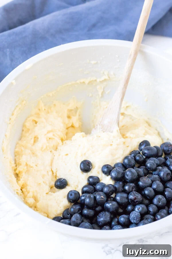 Lemon Blueberry Muffins with Zesty Glaze recipe 4 Lemon blueberry muffin batter in a bowl.