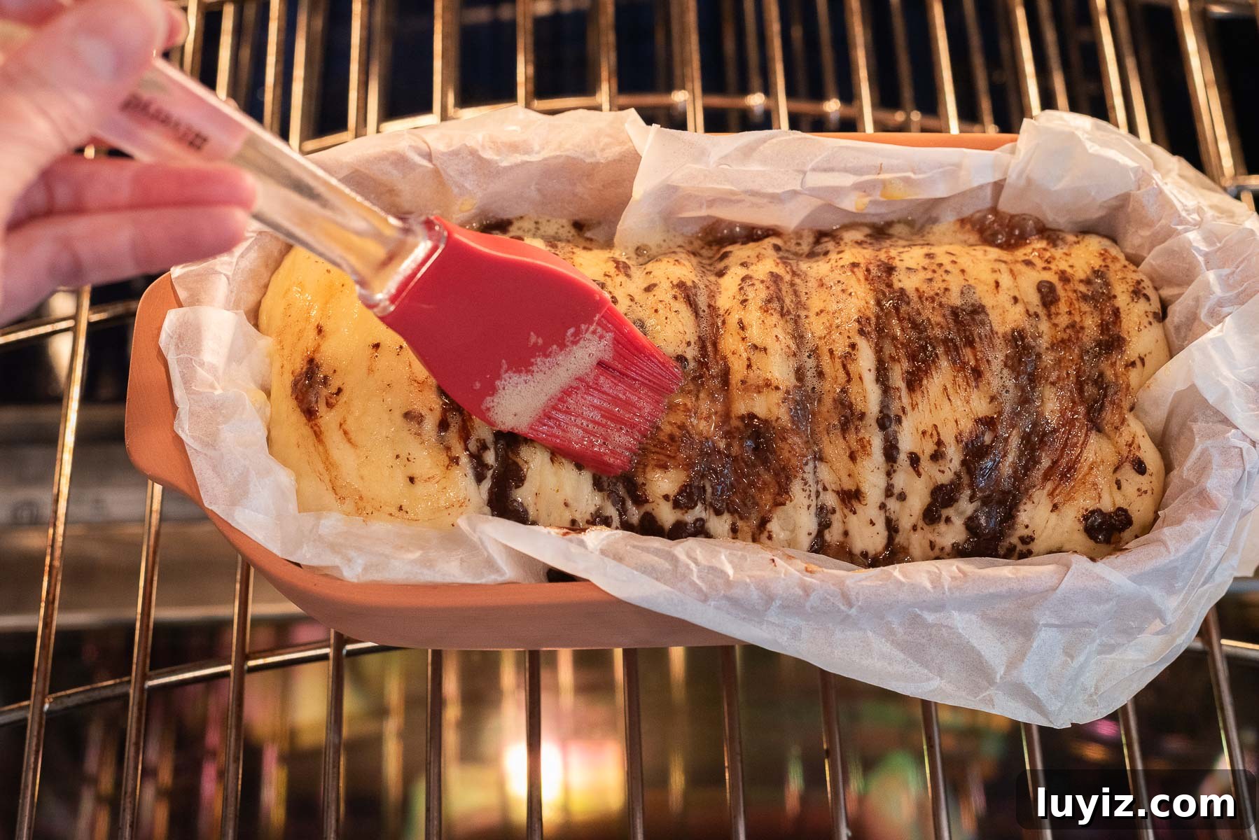 Chocolate Croissant Loaf Recipe: Flaky Chocolate Swirl Bread 17 Brushing the egg wash on the top of the chocolate croissant bread.