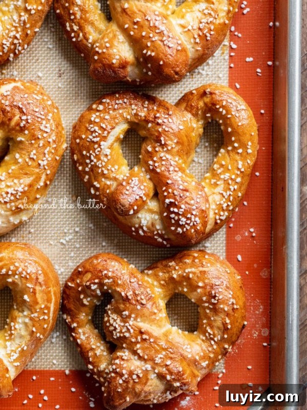 Chocolate Croissant Loaf Recipe: Flaky Chocolate Swirl Bread 21 Homemade soft pretzels on a silicone baking mat and baking sheet.