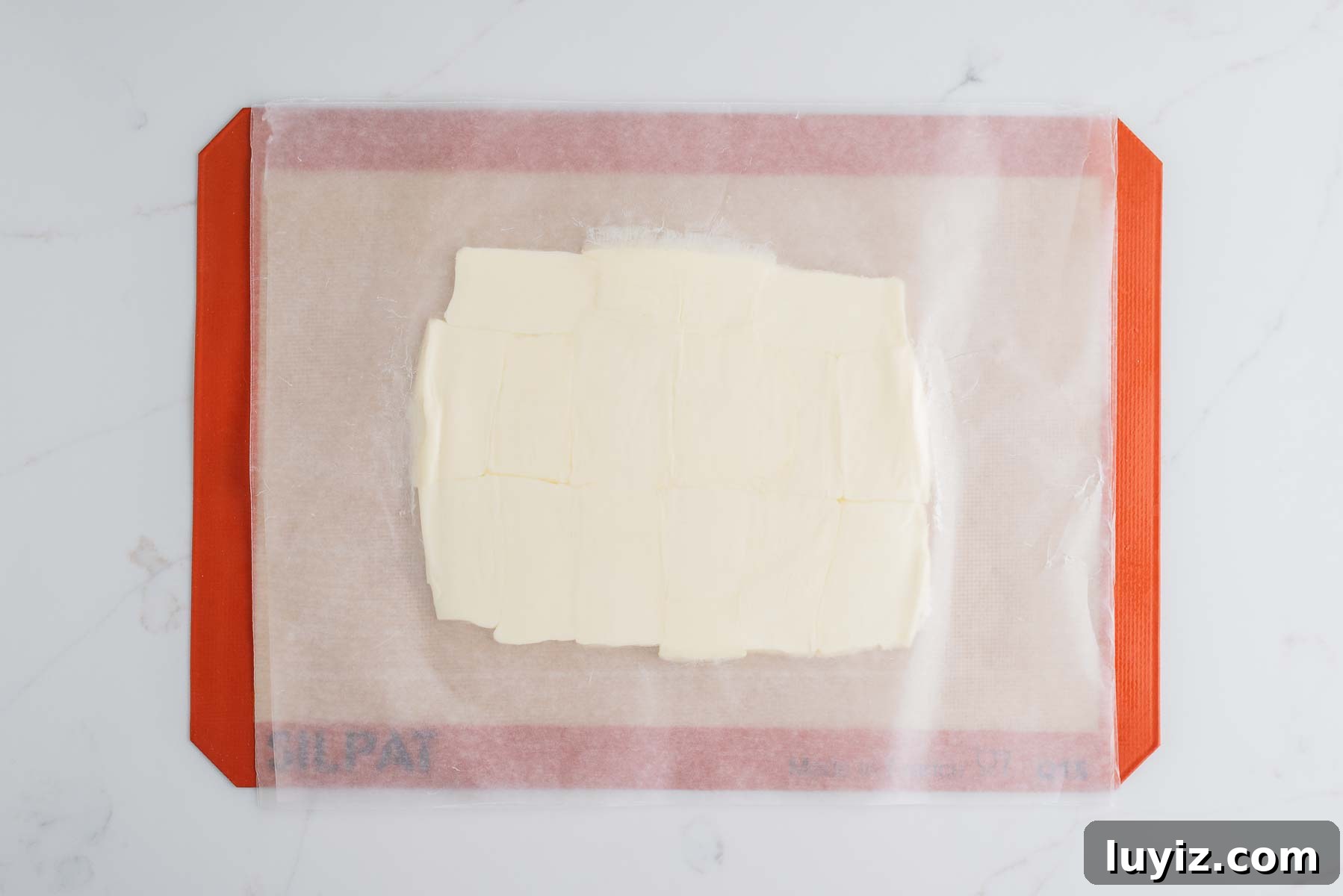 Chocolate Croissant Loaf Recipe: Flaky Chocolate Swirl Bread 9 Rolled butter in a rectangular slab between two sheets of wax paper placed on a silicone baking sheet.