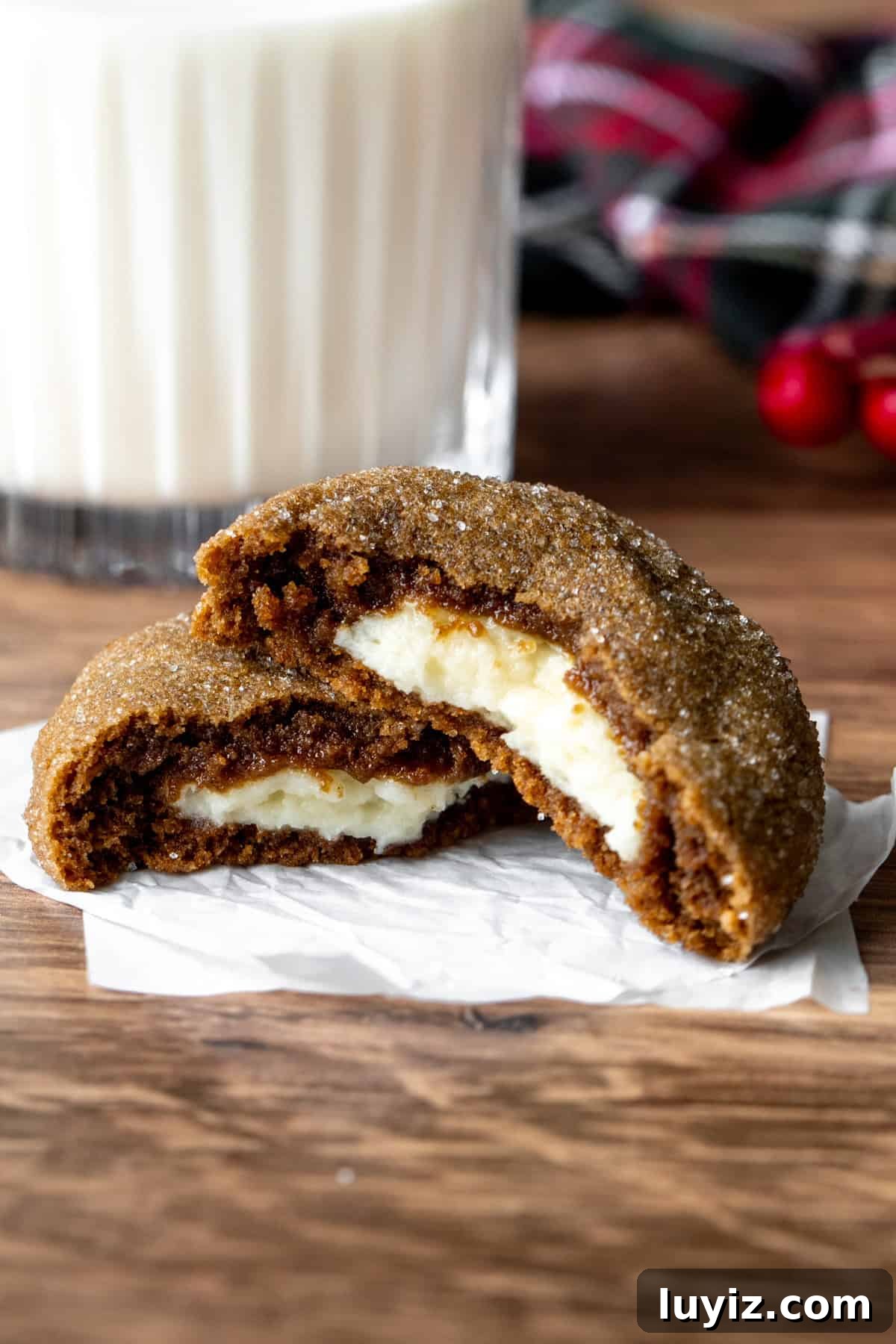 Gingerbread Cheesecake Cookie Recipe: Soft, Spiced Bites 7 Cheesecake stuffed gingerbread cookie broken in half with glass of milk