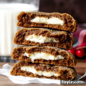 Gingerbread Cheesecake Cookie Recipe: Soft, Spiced Bites 8 Gingerbread cheesecake cookies, broken in half and stacked on top of each other
