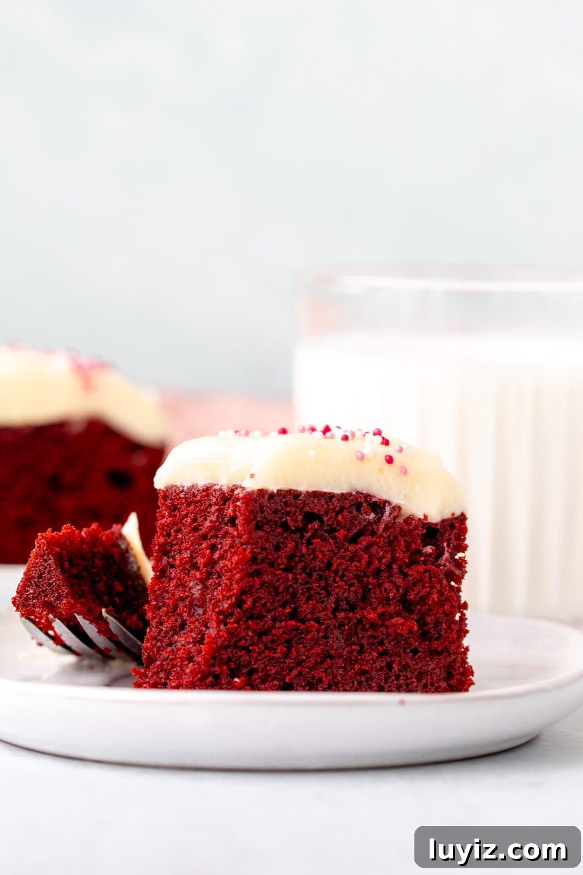 Mini Red Velvet Cake Recipe for Moist, Cream Cheese Frosting 6 Slice of a small red velvet cake with cream cheese frosting on top