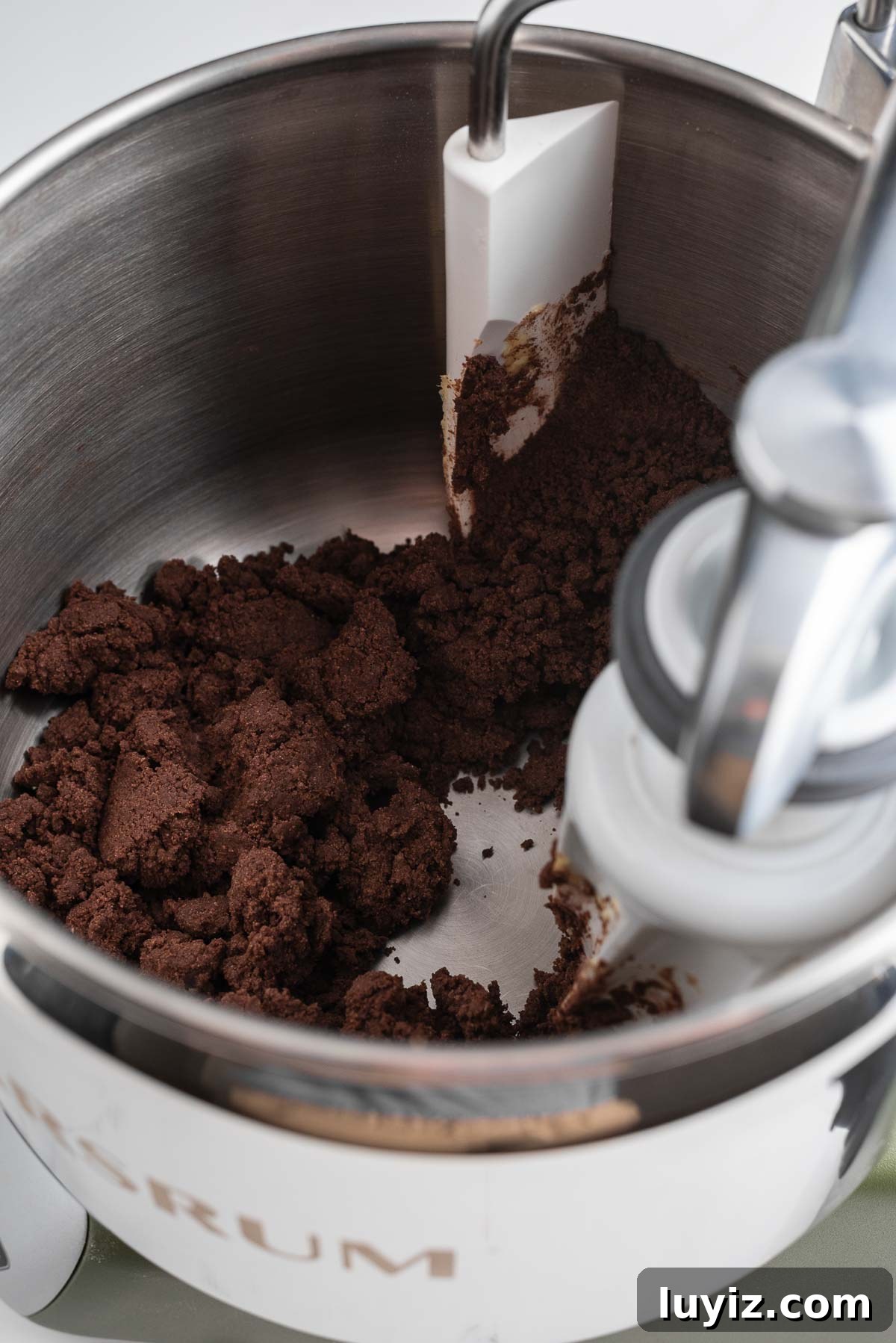 Classic Chocolate Shortbread Cookies Recipe for Homemade Treats 9 Mixed chocolate shortbread dough in a forest green Ankarsrum Assistent Original Mixer on a white marbled surface.