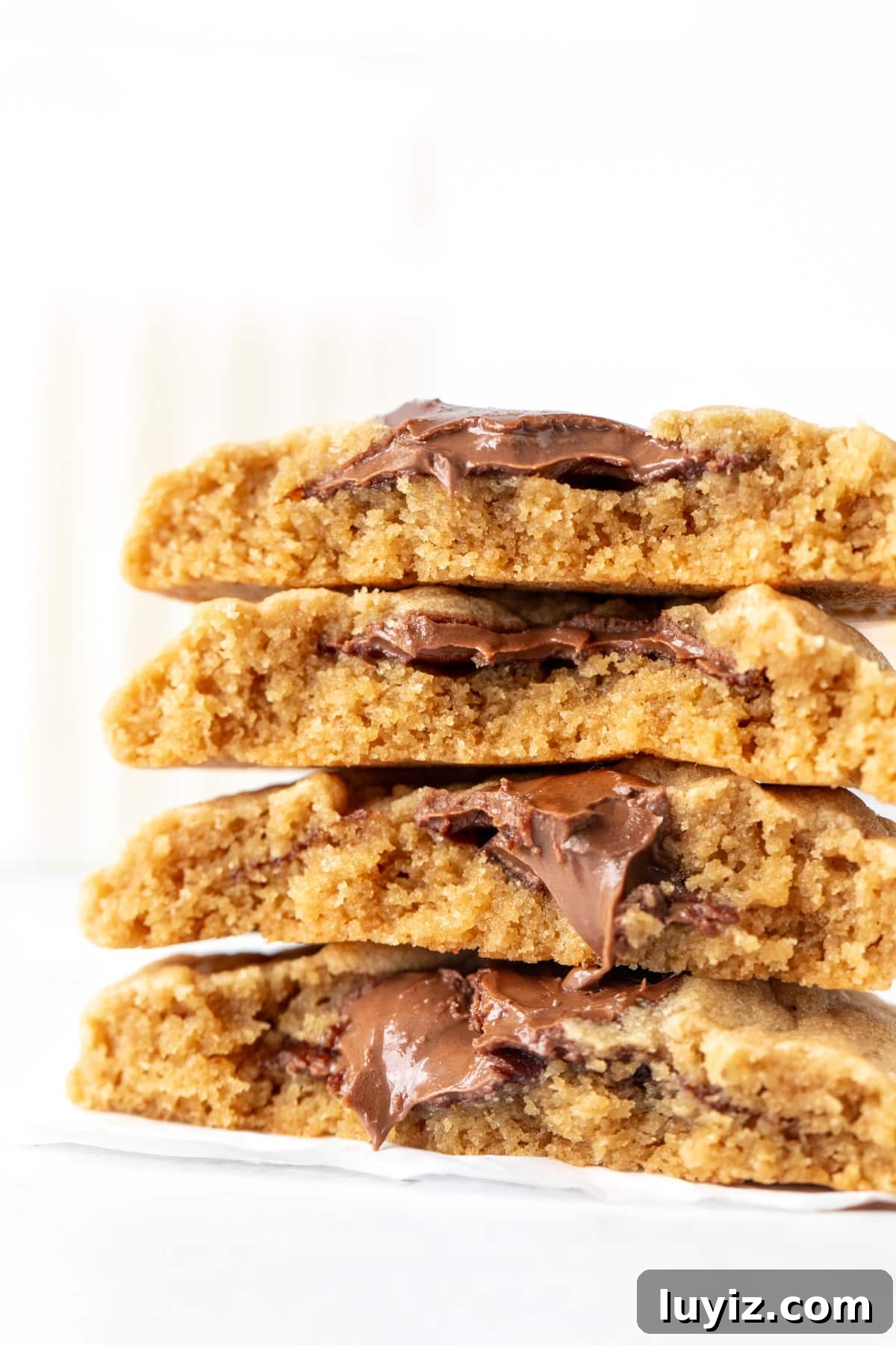Peanut Butter and Nutella Cookie Recipe: Gooey Chocolate Swirl Cookies 2 Stack of peanut butter Nutella cookies, with cookies broken in half and Nutella oozing out