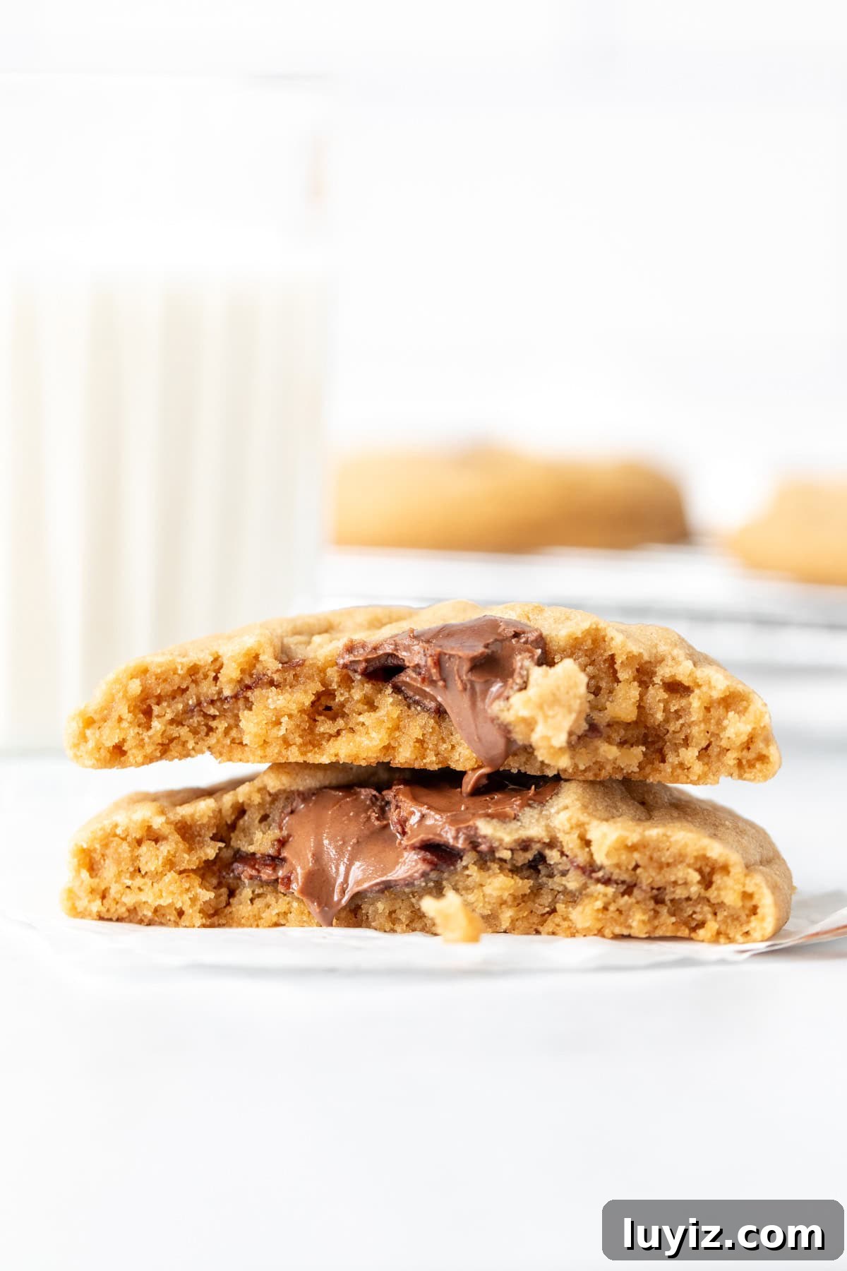 Peanut Butter and Nutella Cookie Recipe: Gooey Chocolate Swirl Cookies 6 Nutella stuffed peanut butter cookie broken in half