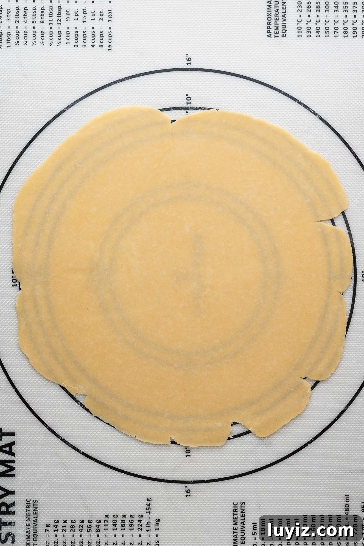 Lemon Cream Pie Recipe: Silky No-Bake Dessert Tutorial 12 Rolled out pie dough on a white silicone lined pastry mat.