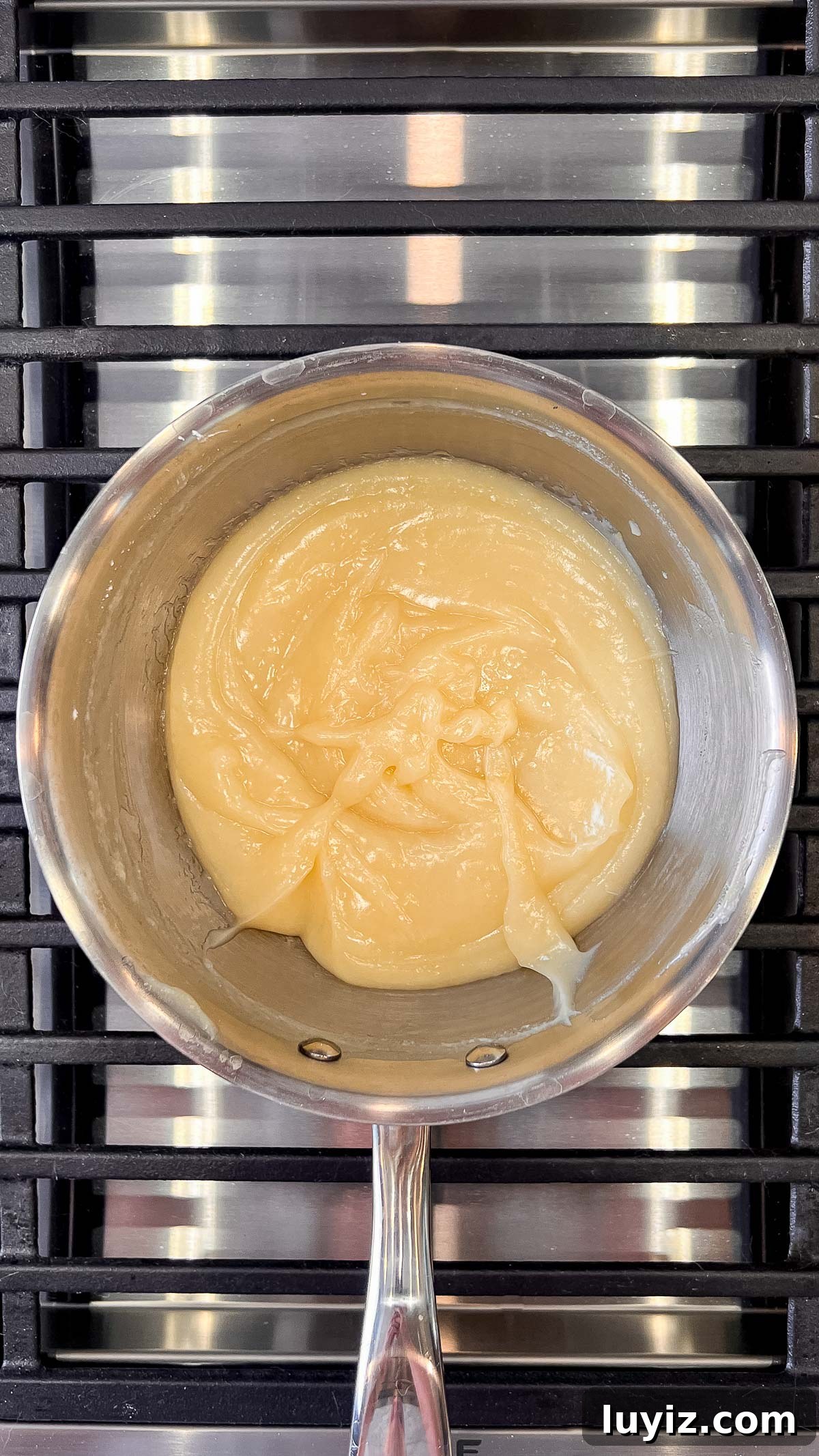 Lemon Cream Pie Recipe: Silky No-Bake Dessert Tutorial 18 Thickened lemon cream pie filling in a medium saucepan over a medium high heat grill.