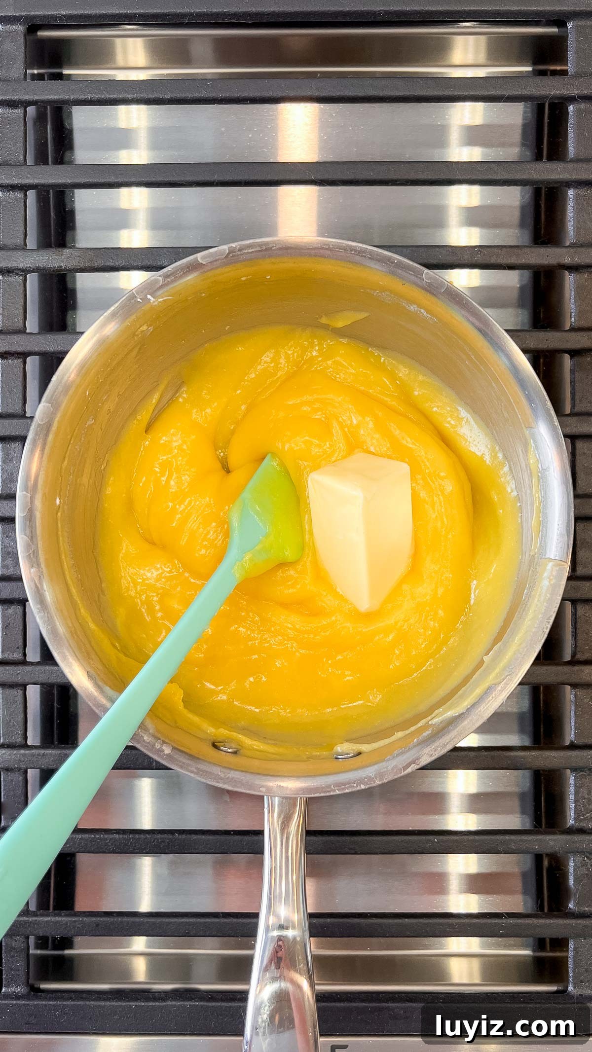 Lemon Cream Pie Recipe: Silky No-Bake Dessert Tutorial 19 Adding butter to lemon cream pie filling mixture in a medium saucepan.