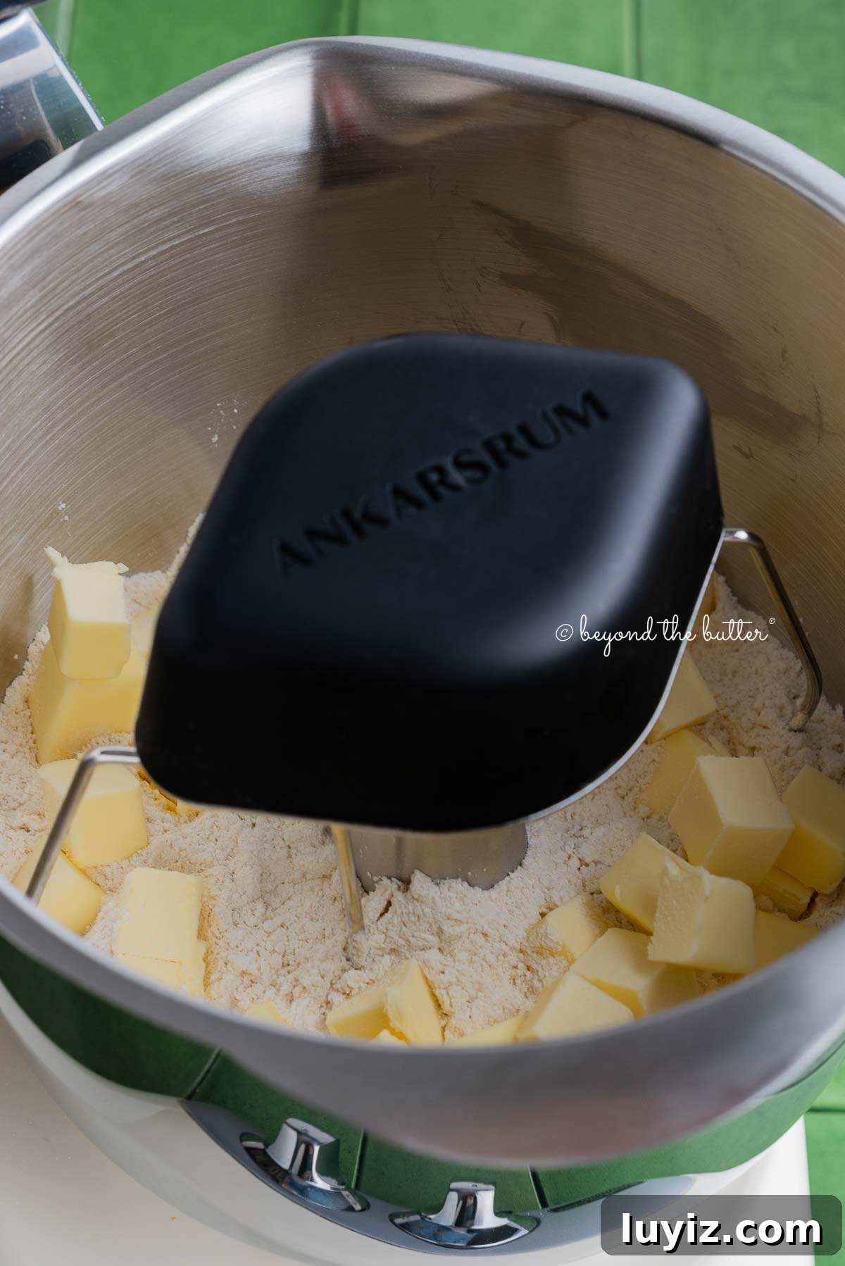 Lemon Cream Pie Recipe: Silky No-Bake Dessert Tutorial 5 Ankarsrum stainless steel beater bowl with new premium beater set attachment mixing pie crust mixture and cold cubed butter together.