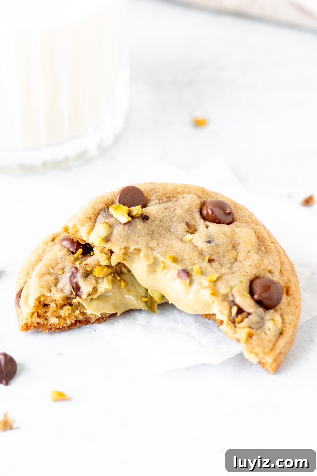 Crispy Pistachio Chocolate Chip Cookies Recipe 9 Pistachio cookie broken in half showing pistachio cream