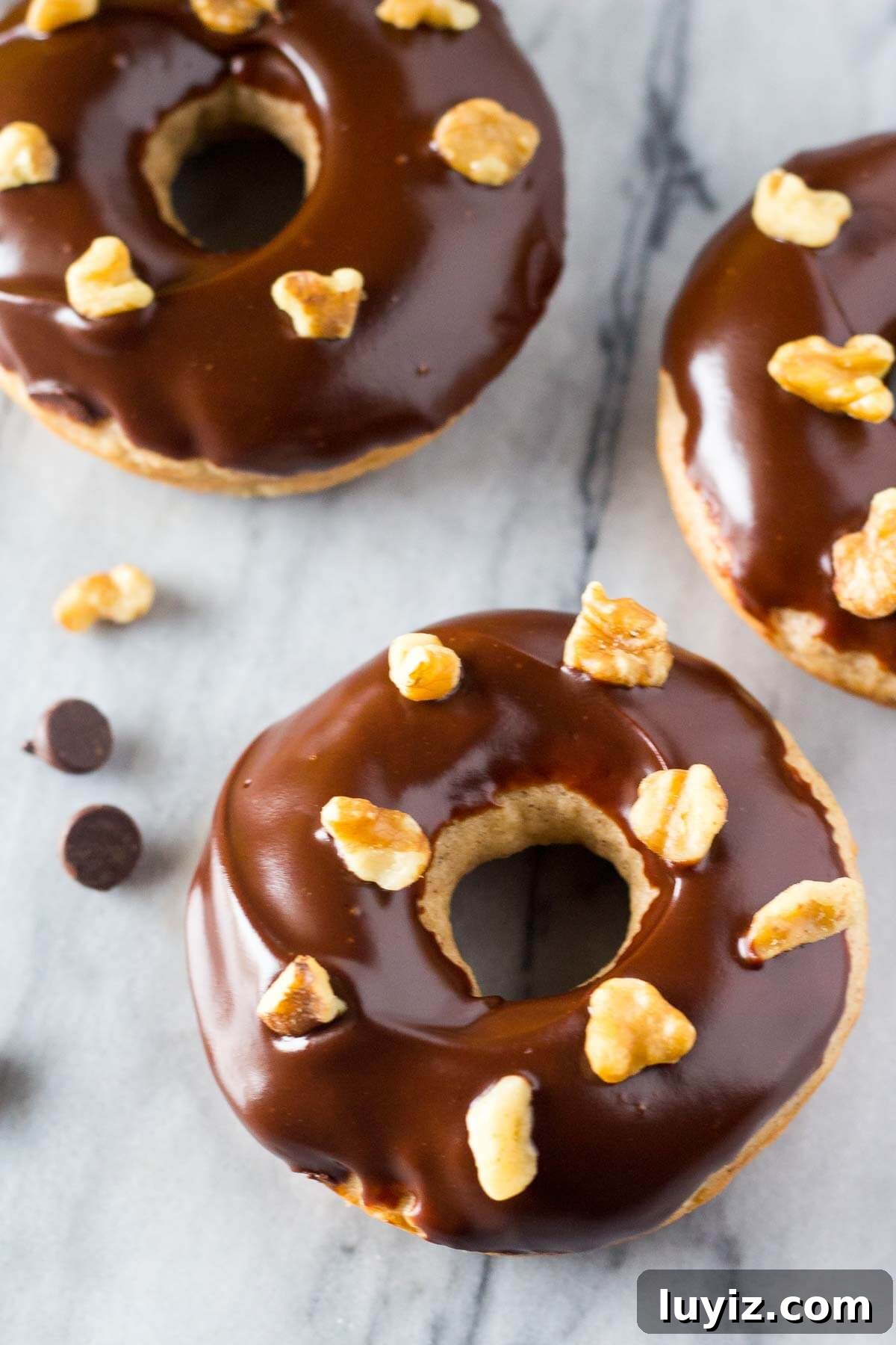 Banana Doughnuts with Silky Chocolate Glaze Recipe 2 Banana Doughnuts with Chocolate Glaze - Baked not fried with big banana bread flavor & so perfect for breakfast!