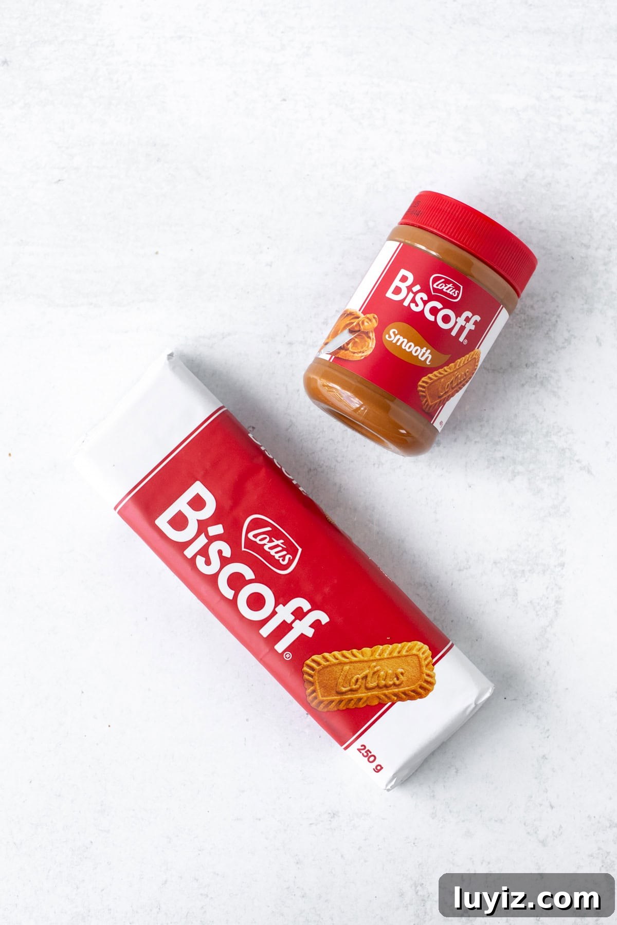 Decadent Biscoff Cheesecake Recipe with Crunchy Cookie Crust 3 Jar of Lotus Biscoff spread and package of Lotus Biscoff cookies
