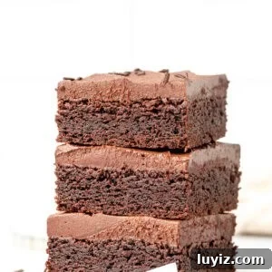 Chocolate Sugar Cookie Bars Recipe with Gooey Chocolate Chips 7 Stack of three chocoalte sugar cookie bars with chocolate frosting