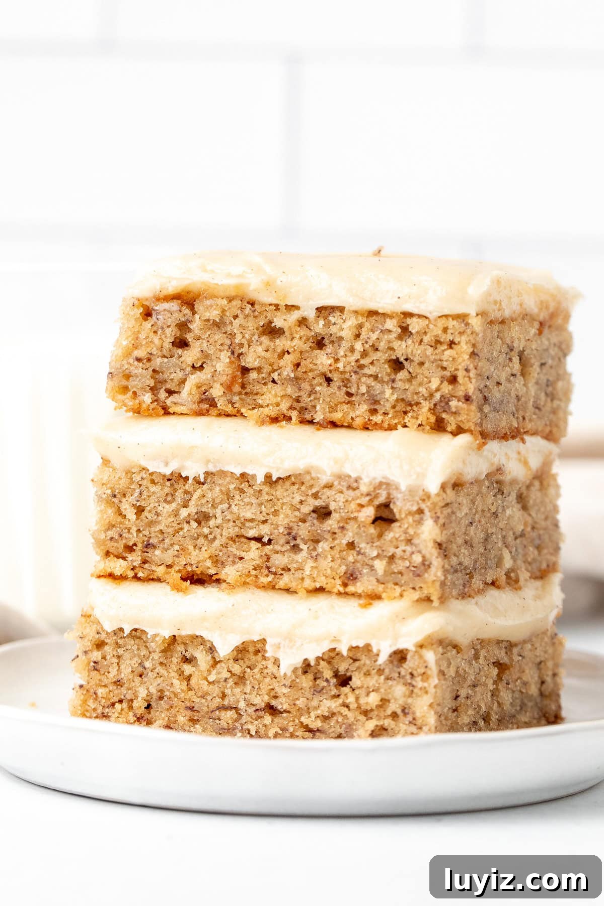 Moist Banana Bars with Cream Cheese Frosting Recipe 7 Stack of three banana bars with cream cheese frosting