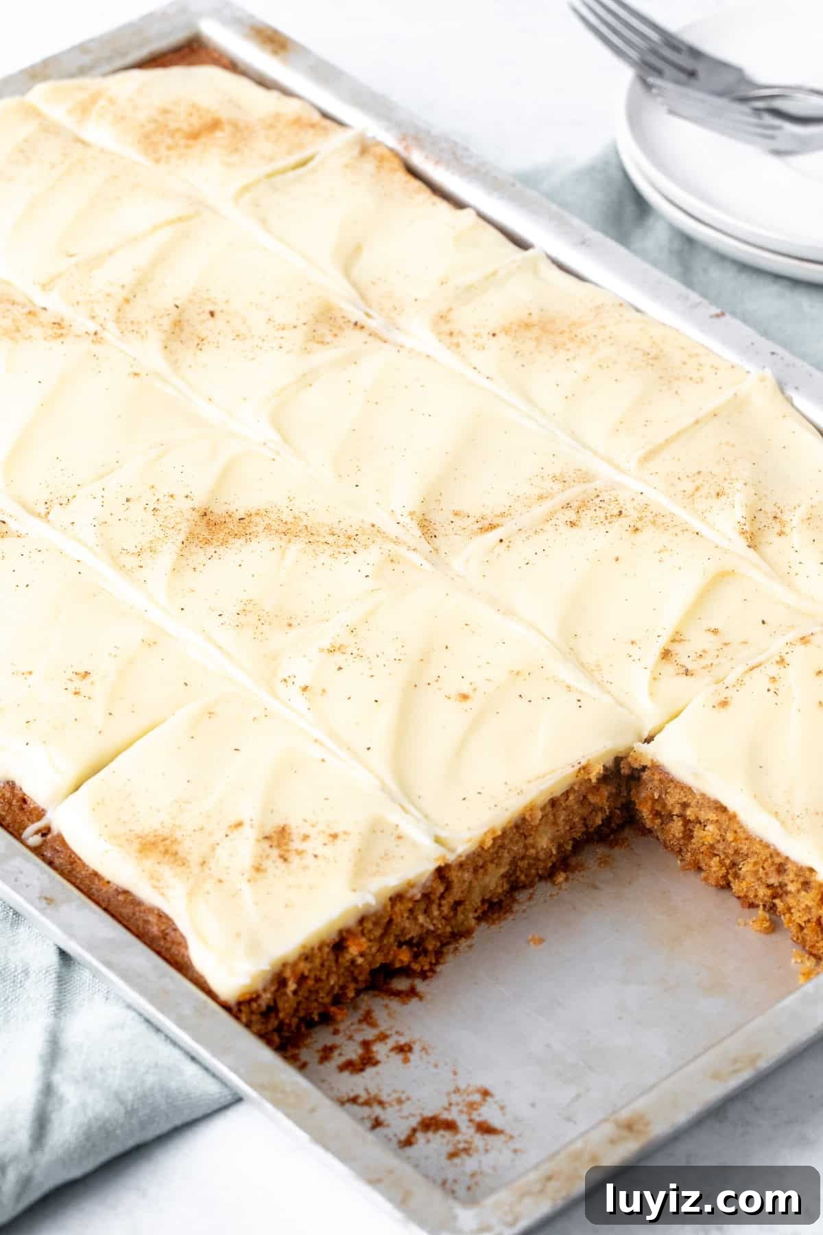 Chewy Carrot Cake Bars with Cream Cheese Frosting 3 Sheet pan of carrot cake bars with cream cheese frosting, cut into squares