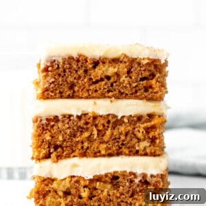 Chewy Carrot Cake Bars with Cream Cheese Frosting 9 Stack of three carrot cake bars with cream cheese frosting
