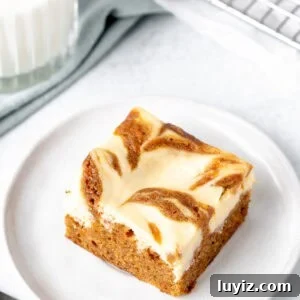 Carrot Cake Cheesecake Bars Recipe — Moist Spiced Dessert Bars 10 Carrot cake cheesecake bar on a plate