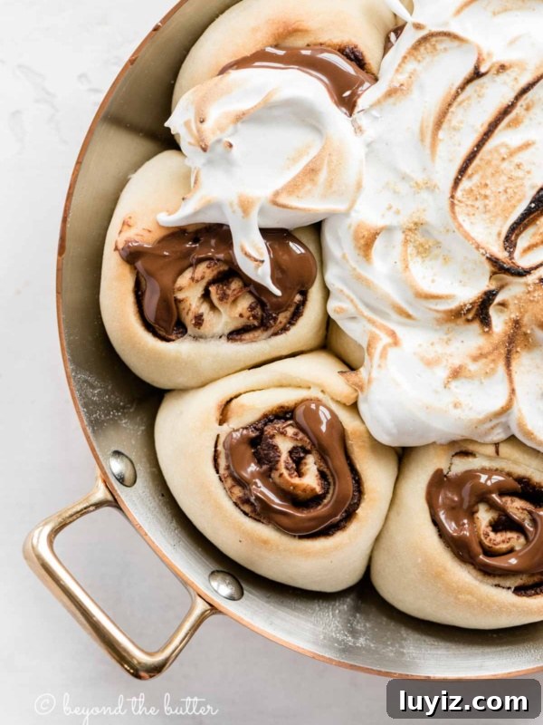 Pennsylvania Dutch Fasnacht Donuts: Traditional Recipe & History 11 Overhead closeup image of s'mores rolls partially covered with marshmallow topping.