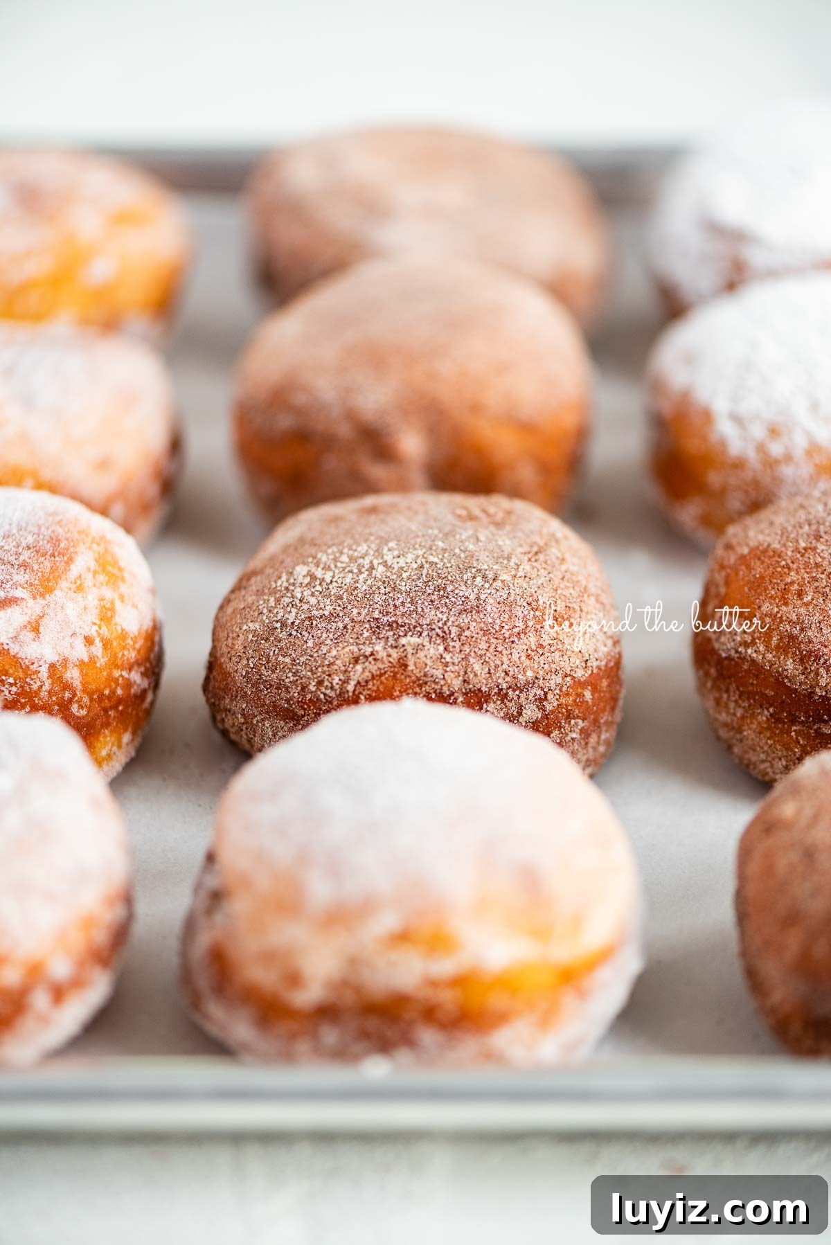 Pennsylvania Dutch Fasnacht Donuts: Traditional Recipe & History 5 Fasnacht doughnuts on a parchment paper lined baking sheet | © Beyond the Butter®