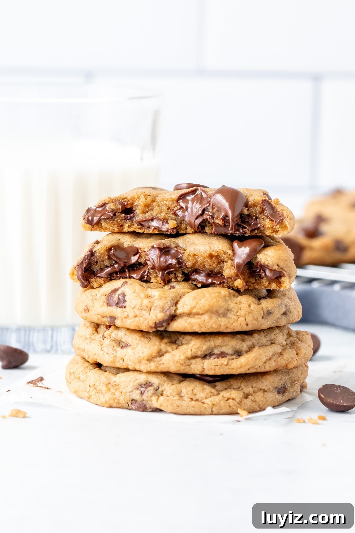Cream Cheese Chocolate Chip Cookie Recipe for Extra Chewy Cookies 2 Stack of cream cheese chocolate chip cookies with top cookie broken in half.