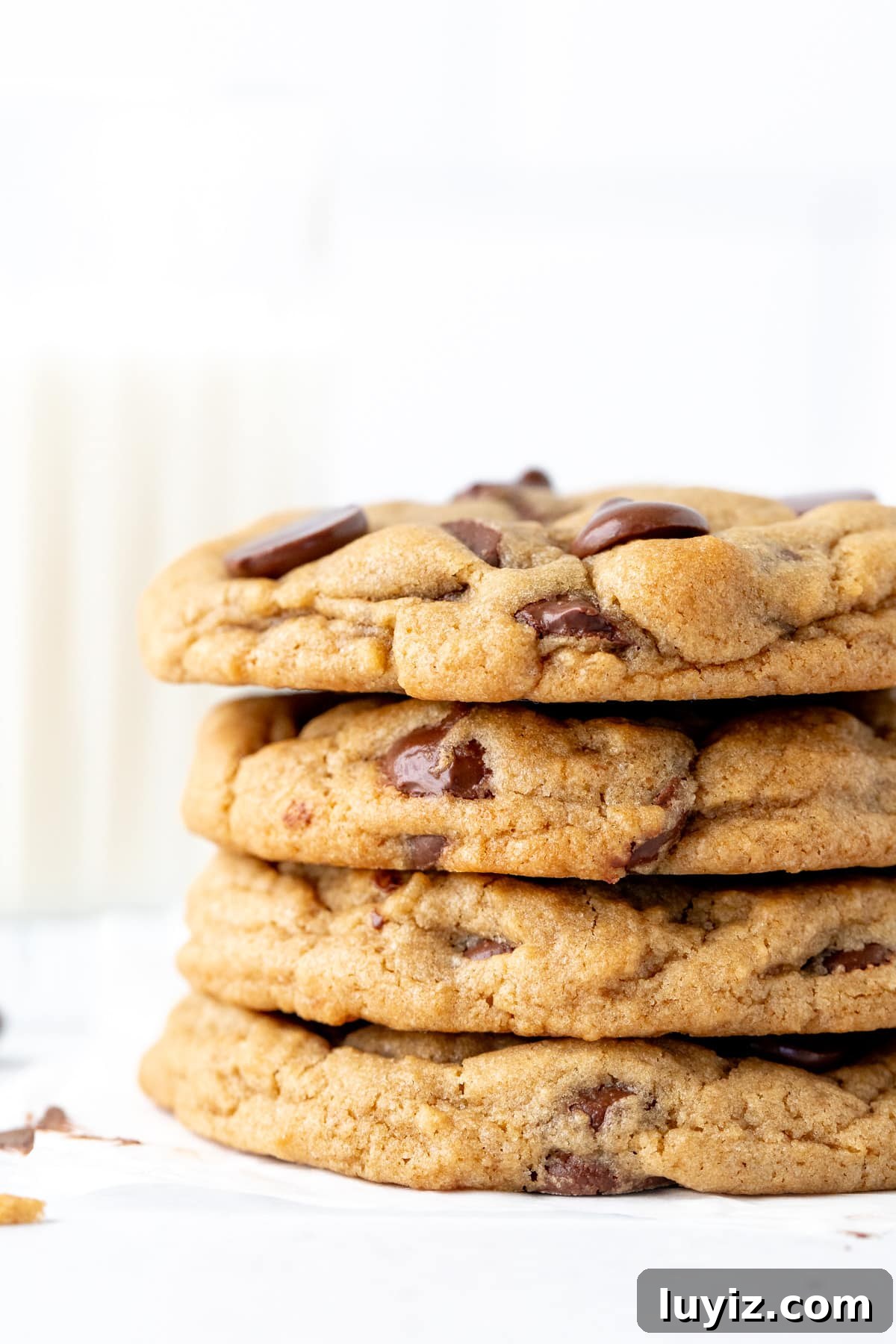 Cream Cheese Chocolate Chip Cookie Recipe for Extra Chewy Cookies 3 4 cream cheese chocolate chip cookies, one on top of each other with glass of milk