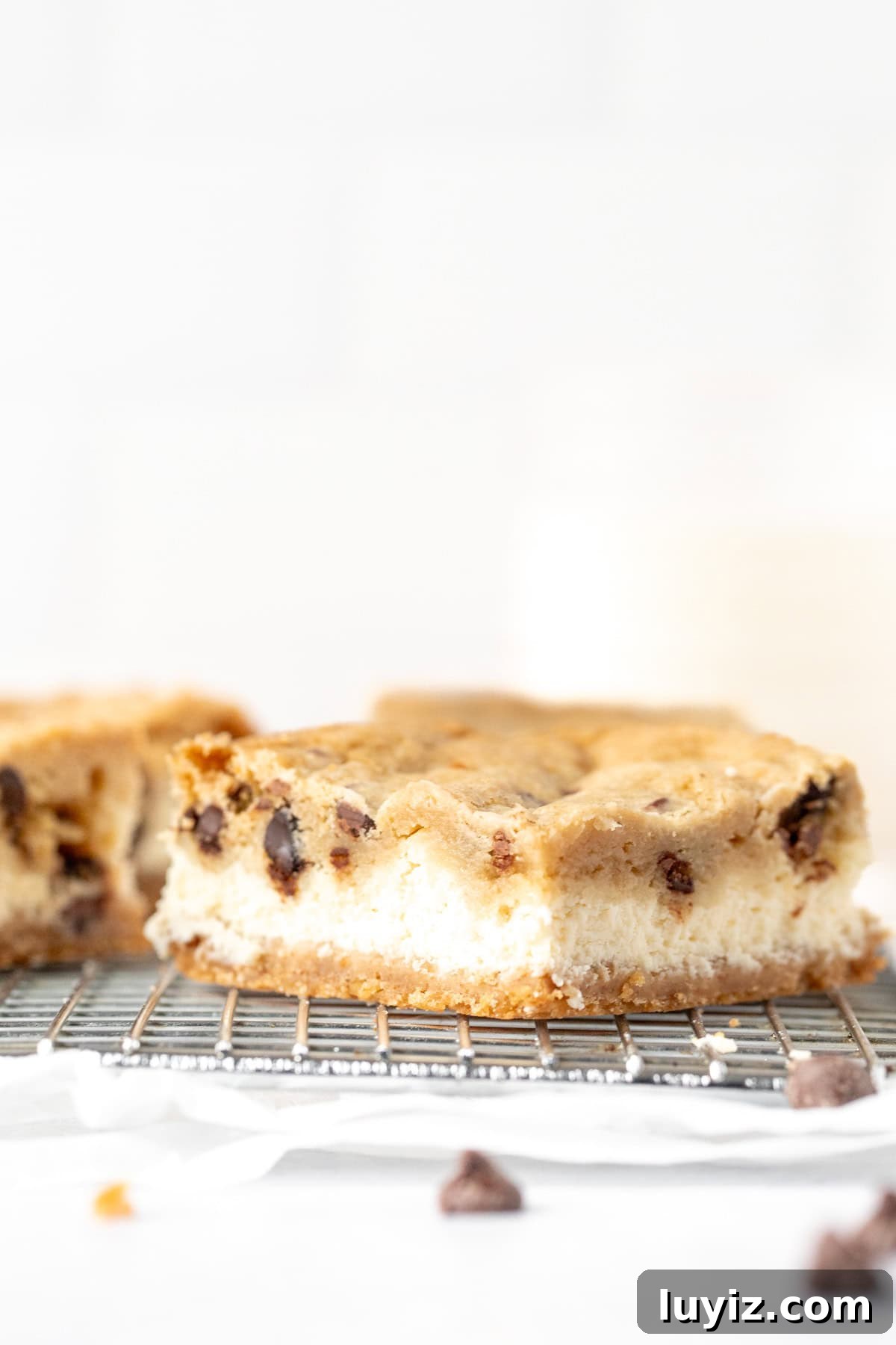 Chocolate Chip Cheesecake Bars Recipe for Rich, Creamy Dessert 4 Chocolate chip cookie cheesecake bar on a cooling rack