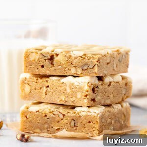 Brown Butter Maple Blondies with Sea Salt Drizzle 8 Stack of three maple nut blondies drizzled with maple glaze