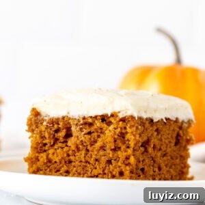 Ultimate Moist Pumpkin Cake Recipe for Fall Baking 11 Slice of pumpkin cake with brown butter cream cheese frosting