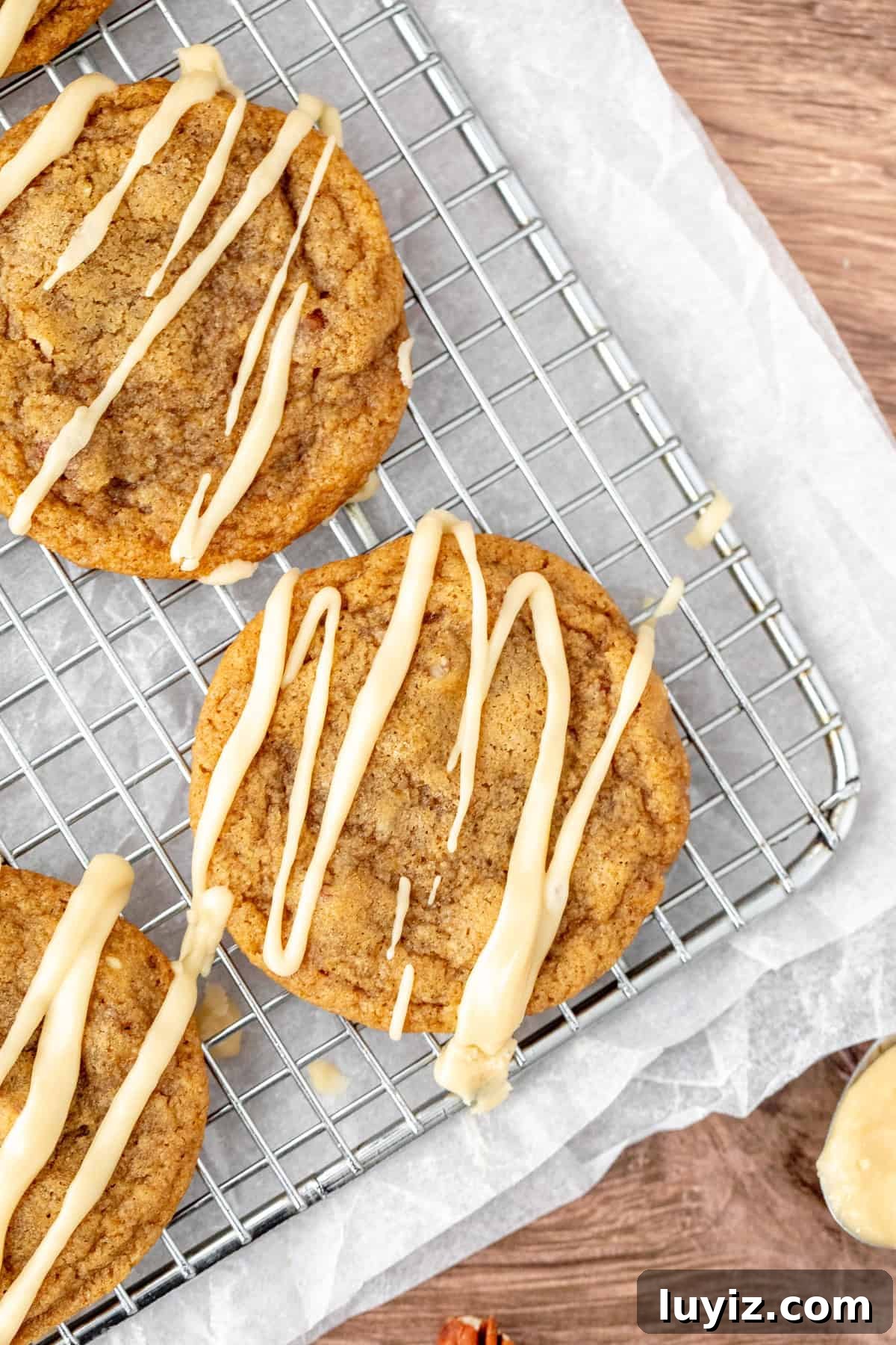 Maple Sugar Cookies with Creamy Maple Icing 6 Maple cookies drizzled with maple glaze on a cooling rack