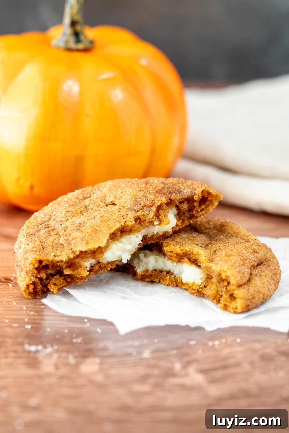 Pumpkin Cheesecake Cookie Recipe — Soft Pumpkin Cookies with Creamy Filling 4 pumpkin cheesecake cookie, broken in half