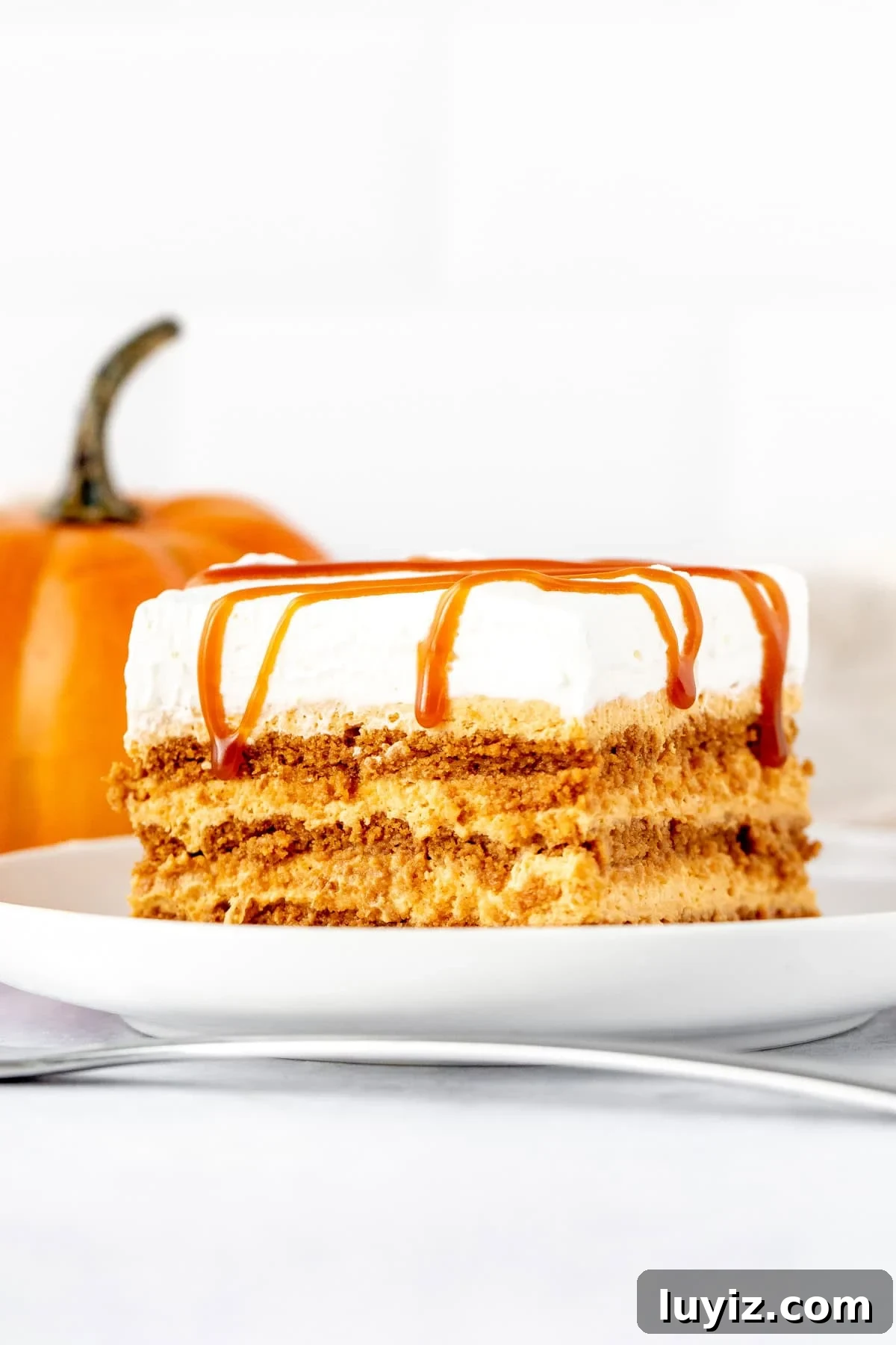 No-Bake Pumpkin Icebox Cake Recipe for Fall Desserts 2 Slice of pumpkin icebox cake topped with whipped cream and caramel sauce