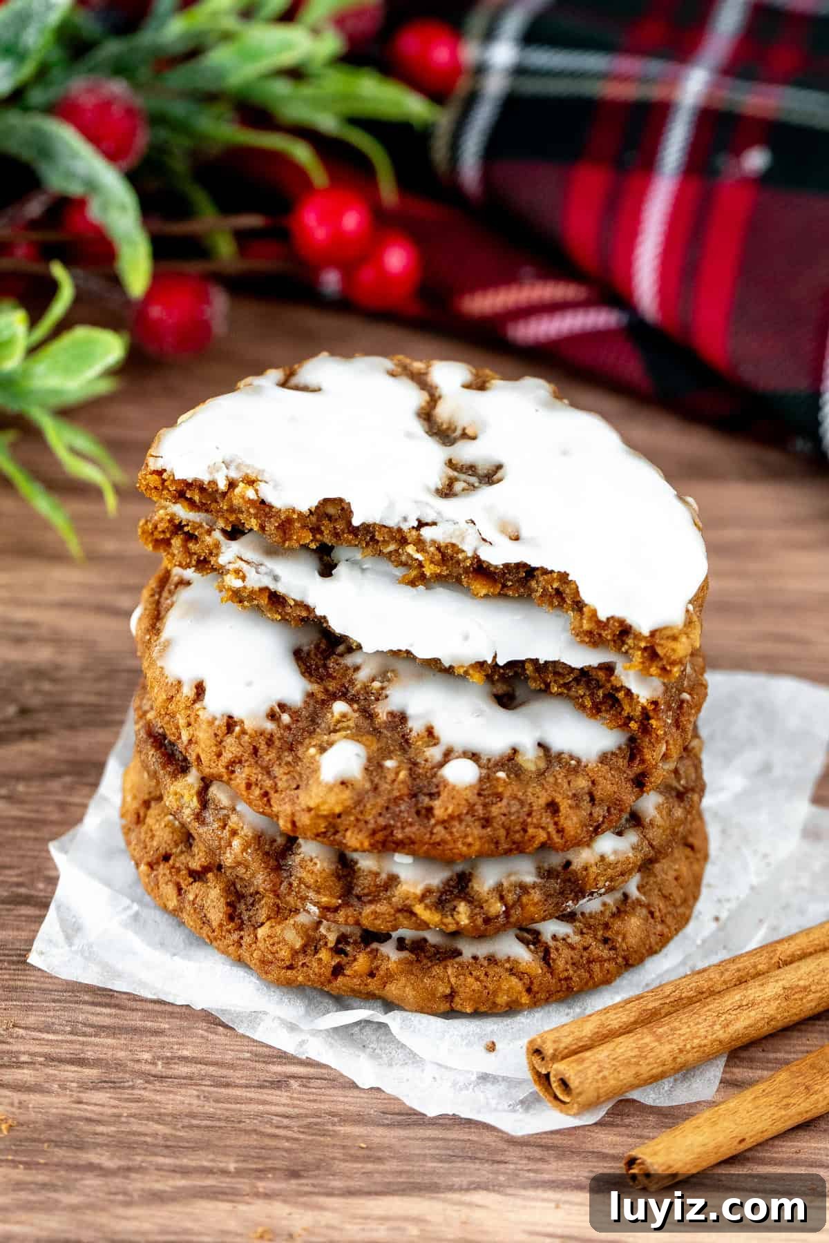 Gingerbread Oatmeal Cookies with Sweet Icing 6 Stack of iced gingerbread oatmeal cookies, with top cookie broken in half.