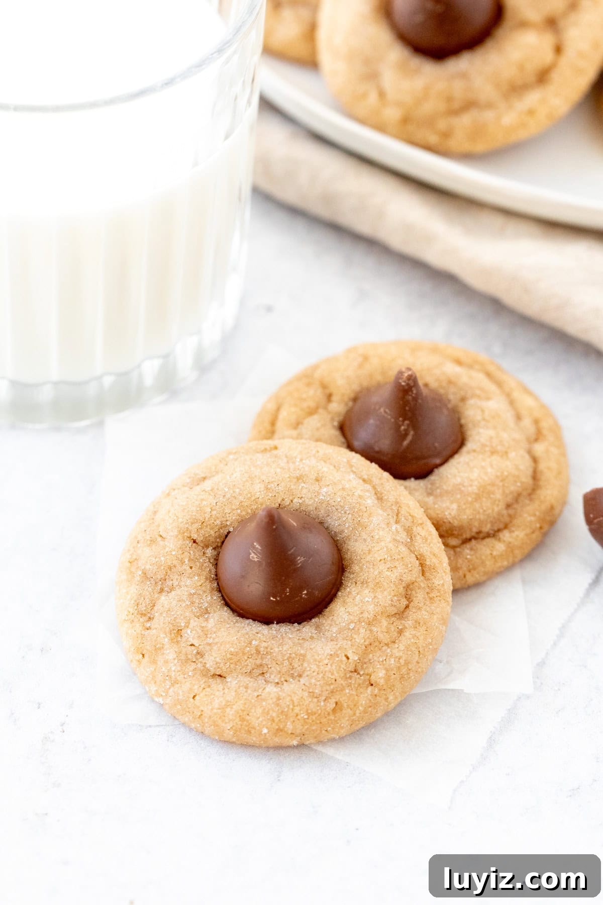 Classic Peanut Butter Blossom Cookies: Soft Baked Chocolate Kiss Cookies 4 Two peanut butter Hershey's Kiss cookies with glass of milk
