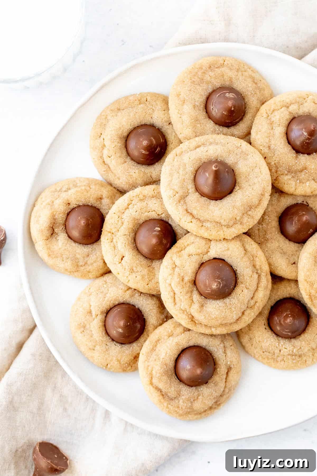 Classic Peanut Butter Blossom Cookies: Soft Baked Chocolate Kiss Cookies 8 Peanut butter blossoms cookies on a plate