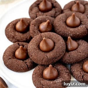 Chocolate Blossom Cookies Recipe: Soft Chocolate Thumbprint Treats 6 plate of chocolate cookies with Hershey's chocolate kiss on top