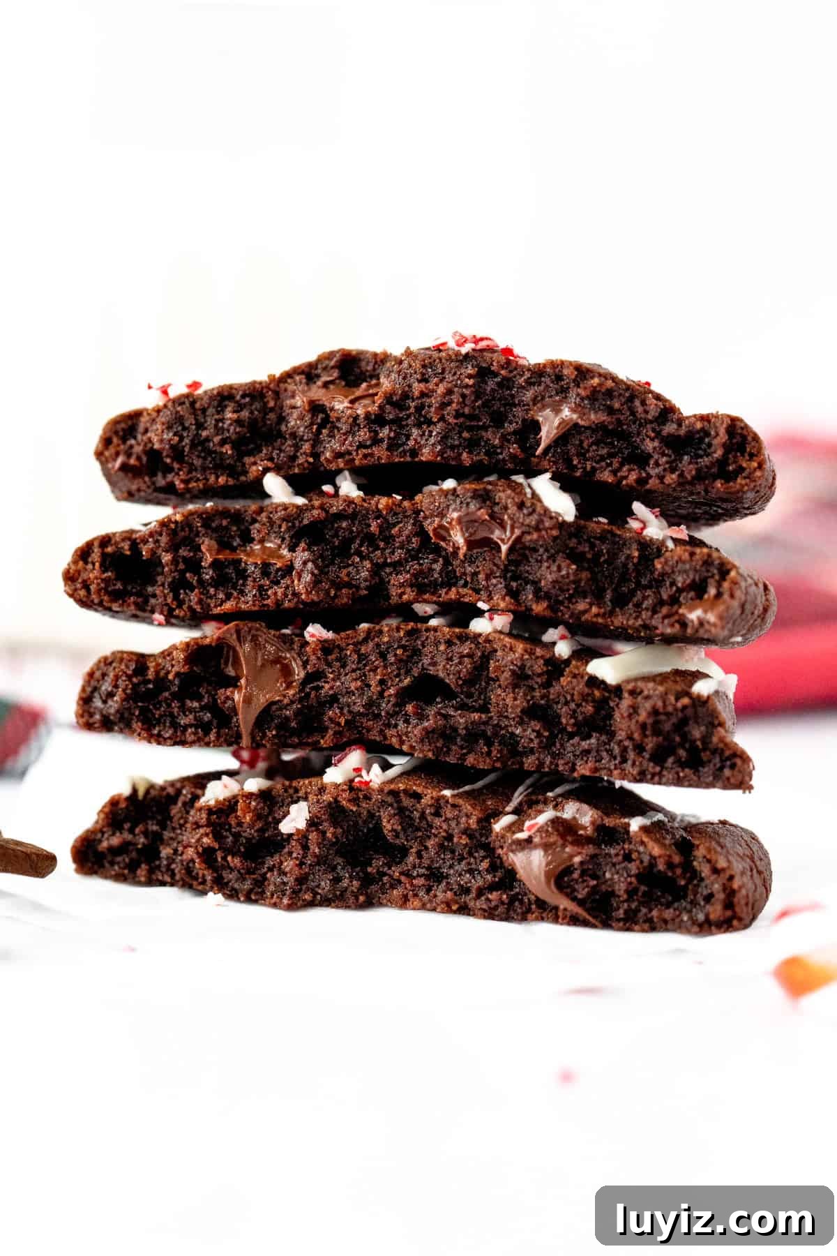 Peppermint Mocha Cookie Recipe — Festive Chocolate Coffee Cookies 7 Peppermint mocha chocolate cookies broken in half, and stacked on top of another
