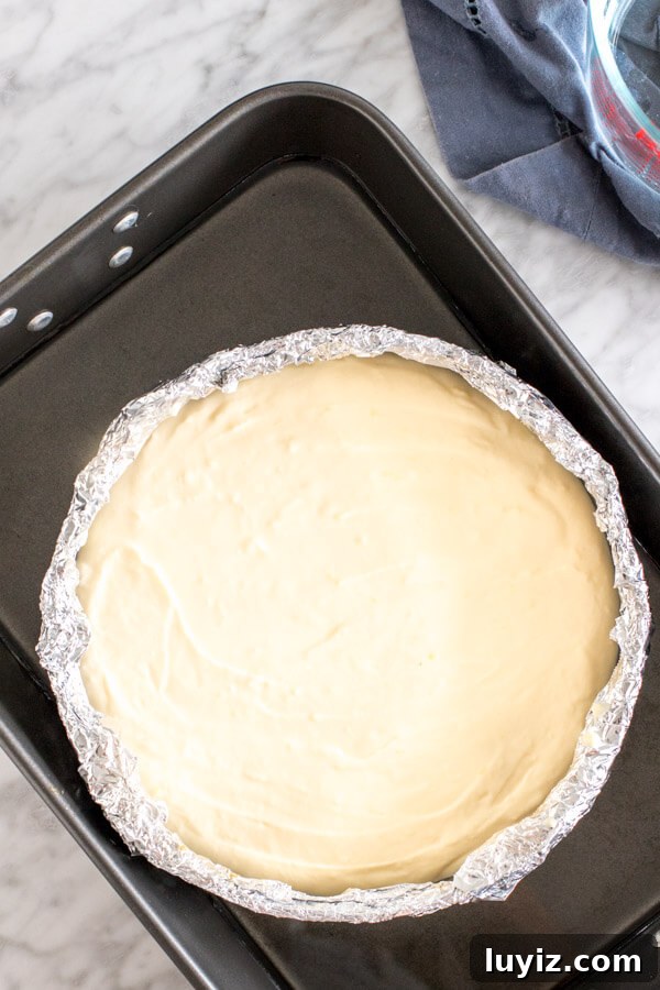 Lemon Cheesecake with Blueberry Compote Recipe 4 Unbaked lemon cheesecake in water bath.