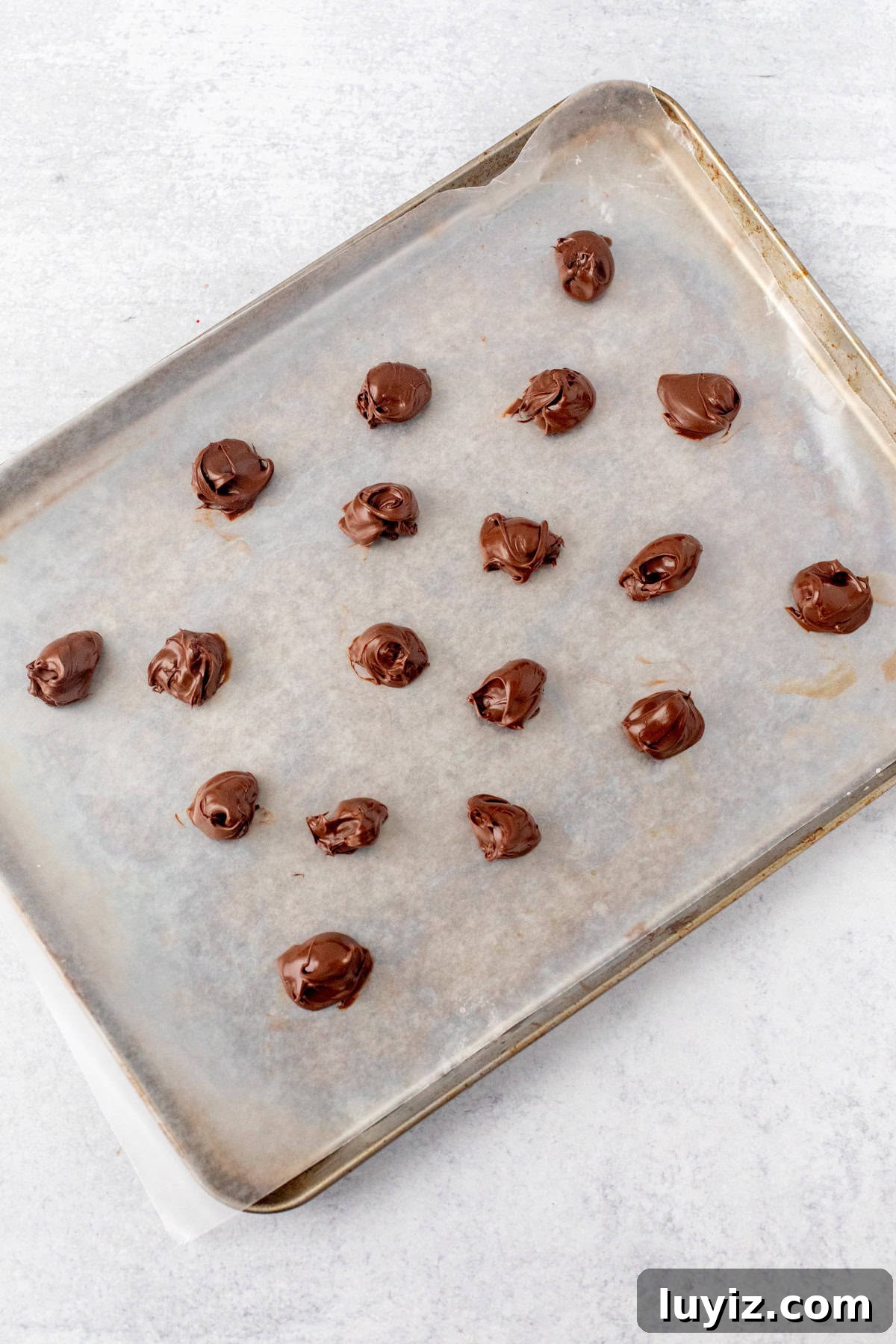 Nutella-Filled Double Chocolate Cookies 4 Lined cookie tray with dollops of Nutella