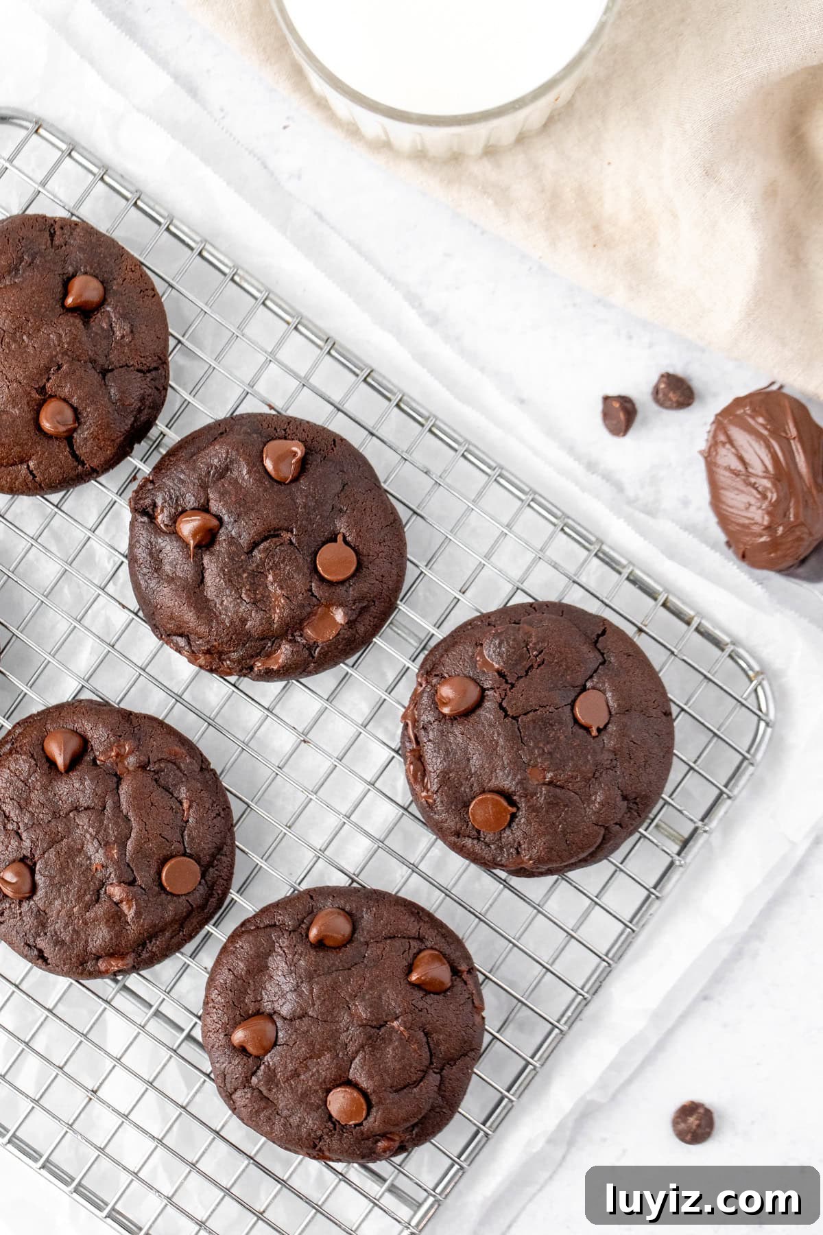 Nutella-Filled Double Chocolate Cookies 6 Double chocolate cookies, stuffed with Nutella, on a cooling tray