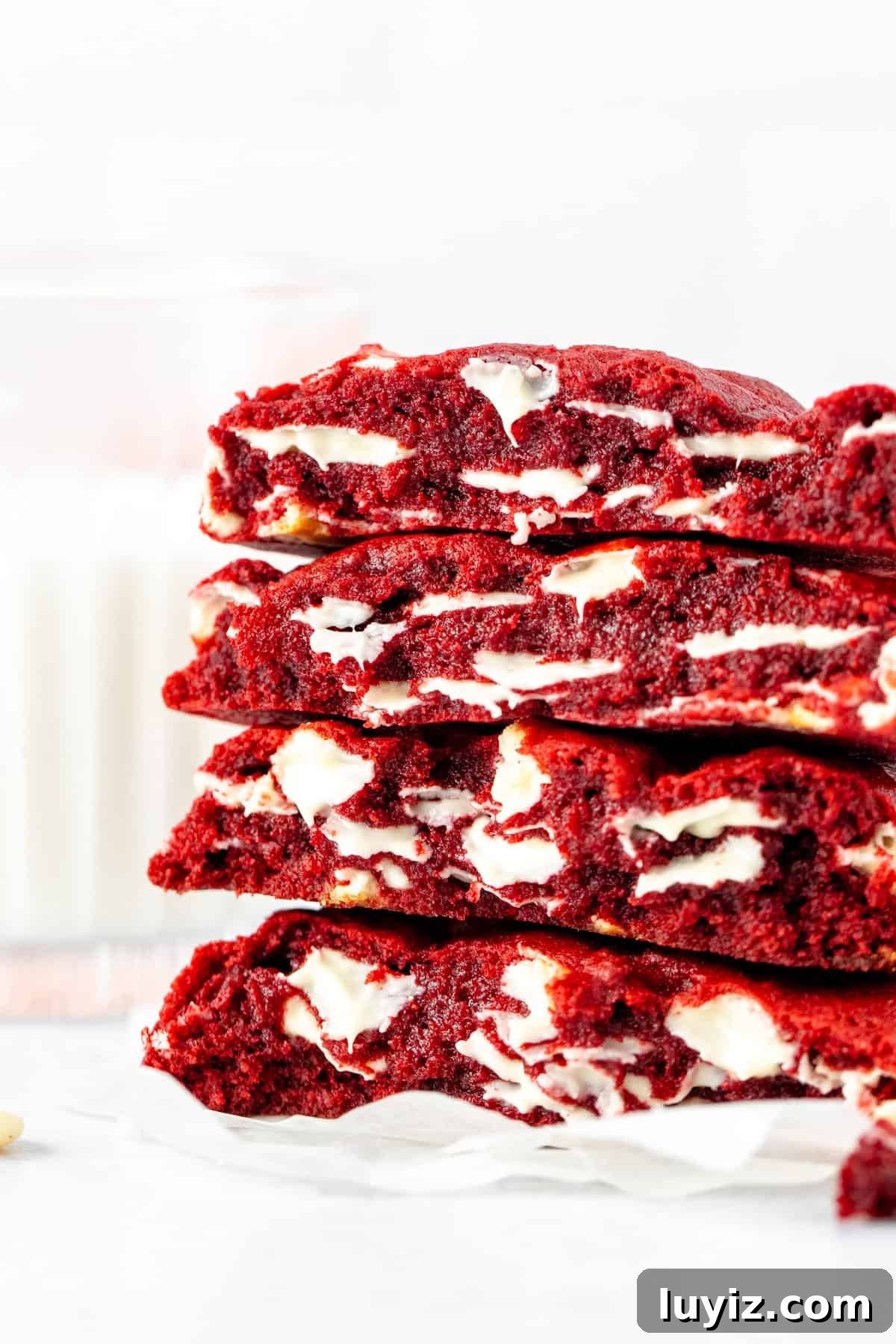 Bakery-Style Extra-Thick Red Velvet Cookies 2 Stack of bakery-style red velvet cookies, broken in half
